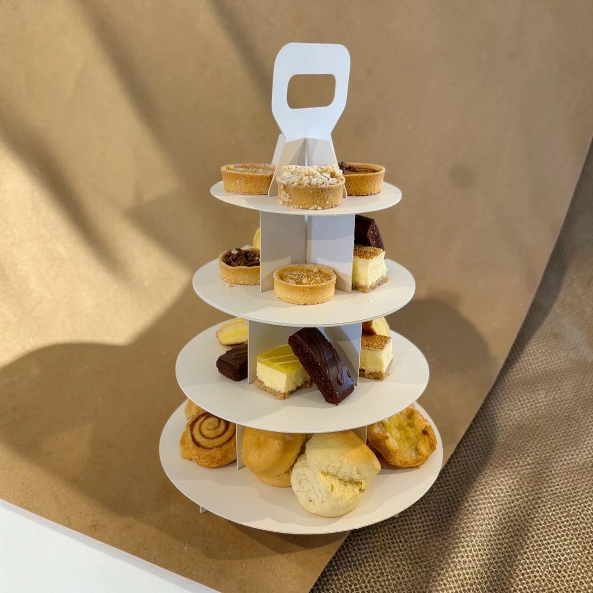 Donut Bouquet Canberra gourmet high tea set with assorted pastries and cheesecakes on a three-tier white stand